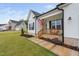 Inviting front porch with wooden railings and brick base, complemented by fresh landscaping and an American flag at 297 Sexton Ln, Wendell, NC 27591