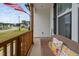 Charming front porch with a wicker chair, decorated with floral pillows, and a view of the street with manicured lawns at 297 Sexton Ln, Wendell, NC 27591
