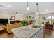 Open concept kitchen with large granite island flowing into the living and dining areas at 297 Sexton Ln, Wendell, NC 27591