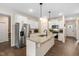 Modern kitchen with stainless steel appliances, granite countertops, and white cabinetry at 297 Sexton Ln, Wendell, NC 27591