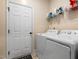 Practical laundry room features a washer and dryer and additional shelving at 297 Sexton Ln, Wendell, NC 27591