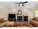 Comfortable living room featuring plush sofas, a fireplace with decorative mantel, and a ceiling fan for climate control at 297 Sexton Ln, Wendell, NC 27591