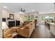Spacious living room with fireplace, neutral walls, and hardwood floors, seamlessly connecting to the dining area and kitchen at 297 Sexton Ln, Wendell, NC 27591