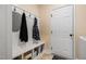 Functional mudroom area with a built-in bench, storage cubbies, and hooks for organization at 297 Sexton Ln, Wendell, NC 27591