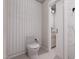 Clean, modern bathroom featuring a toilet and adjacent vanity and sink with modern fixtures and tile backsplash at 300 Westerman Pl, Smithfield, NC 27577