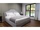 Bedroom featuring a plush bed, large window with natural light, and stylish wall decor at 300 Westerman Pl, Smithfield, NC 27577