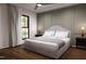 Bedroom featuring a plush bed, large window with natural light, and stylish wall decor at 300 Westerman Pl, Smithfield, NC 27577