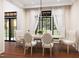 Elegant dining room with modern chandelier and natural light from large windows at 300 Westerman Pl, Smithfield, NC 27577