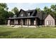 Stunning exterior elevation of this home featuring a large porch and manicured lawn at 300 Westerman Pl, Smithfield, NC 27577