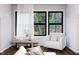 Bright living space featuring a cozy armchair, table with decor, and a view of the outdoors through large windows at 300 Westerman Pl, Smithfield, NC 27577