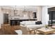 Bright living area with hardwood floors, a comfortable sofa, and a view into the kitchen at 300 Westerman Pl, Smithfield, NC 27577