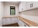 Spacious pantry with extensive cabinet storage, attractive wood countertops, and natural light from a window at 300 Westerman Pl, Smithfield, NC 27577