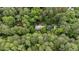 An aerial perspective of a house nestled among verdant trees, showcasing its peaceful seclusion at 3125 Stanford Dr, Durham, NC 27707