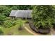 Aerial view of a quaint home with a brick path, lush greenery, mature trees, and a well-maintained landscape at 3125 Stanford Dr, Durham, NC 27707