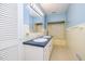 Light blue bathroom with a double sink vanity, large mirror, and combination tub and shower at 3125 Stanford Dr, Durham, NC 27707