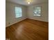 Cozy bedroom with hardwood floors and two windows offering plenty of natural light at 3125 Stanford Dr, Durham, NC 27707