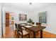 Bright dining room with hardwood floors, a wood table set with seating for four, next to the kitchen at 3125 Stanford Dr, Durham, NC 27707