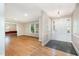 Spacious entryway with hardwood floors, an adjacent living area, and a white front door with glass sidelights at 3125 Stanford Dr, Durham, NC 27707