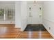 Bright foyer showcasing hardwood floors, a white front door with sidelights, and neutral decor at 3125 Stanford Dr, Durham, NC 27707