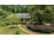 Beautifully landscaped property featuring a one-story home with a red front door and a brick pathway leading to the entrance at 3125 Stanford Dr, Durham, NC 27707