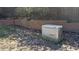 Generac generator sits beside a brick retaining wall, promising power backup at 3125 Stanford Dr, Durham, NC 27707