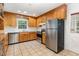 Modern kitchen with stainless appliances, tile floor, light oak cabinets, and granite counters at 3125 Stanford Dr, Durham, NC 27707