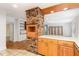 Updated kitchen features an exposed brick accent wall and breakfast bar seating at 3125 Stanford Dr, Durham, NC 27707
