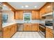 Bright kitchen with oak cabinets, stainless steel appliances, and a window above the double basin sink at 3125 Stanford Dr, Durham, NC 27707