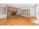 Living room featuring hardwood floors, a fireplace, and a built-in bookcase at 3125 Stanford Dr, Durham, NC 27707