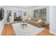 Cozy living room featuring hardwood floors, a modern sofa, and a dining area in the background at 3125 Stanford Dr, Durham, NC 27707