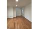 Bright living room featuring hardwood floors and neutral walls with ample natural light at 3125 Stanford Dr, Durham, NC 27707