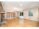 Spacious living room with wood floors, built-in shelving, and sliding glass doors leading to the outdoors at 3125 Stanford Dr, Durham, NC 27707