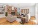 Spacious living room featuring a cozy fireplace, built-in bookshelves, and hardwood floors at 3125 Stanford Dr, Durham, NC 27707