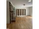 Open living room with hardwood floors, brick fireplace, and built-in shelving at 3125 Stanford Dr, Durham, NC 27707