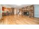 Open living space featuring a brick fireplace, hardwood floors, and a seamless connection to the kitchen at 3125 Stanford Dr, Durham, NC 27707