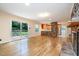 Bright living room with wood floors, brick fireplace, and sliding glass door offering a view of the backyard at 3125 Stanford Dr, Durham, NC 27707