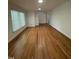 Bright living room featuring hardwood floors and neutral walls with ample natural light at 3125 Stanford Dr, Durham, NC 27707