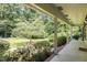 Scenic porch view overlooking a lush green lawn and mature trees, creating a serene outdoor space at 3125 Stanford Dr, Durham, NC 27707