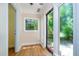Bright sunroom featuring a large glass door, a small window, and durable floors allowing for easy access to the outside at 3125 Stanford Dr, Durham, NC 27707