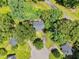 An aerial view shows houses nestled among lush trees, with the cul-de-sac offering a tranquil setting at 324 Waterside Dr, Sanford, NC 27330