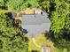 An aerial view showcasing a well-maintained home, mature trees, and lush green lawn at 324 Waterside Dr, Sanford, NC 27330