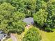 Aerial view of the home nestled among lush mature trees and a well-manicured lawn at 324 Waterside Dr, Sanford, NC 27330
