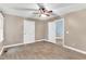 Neutral bedroom with updated flooring, two closets, a ceiling fan, and an open doorway to another room at 324 Waterside Dr, Sanford, NC 27330