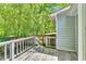 Back deck with railing overlooking wooded lot in a tranquil setting at 324 Waterside Dr, Sanford, NC 27330