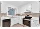 Bright kitchen features stainless appliances, white cabinets, and laminate floors at 324 Waterside Dr, Sanford, NC 27330