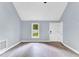 Bright living room with updated floors, neutral paint, a large window for natural light, and a view of the front door at 324 Waterside Dr, Sanford, NC 27330
