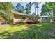 A spacious backyard with a wooden deck on a yellow house offers ample outdoor space at 3359 Denise St, Durham, NC 27704
