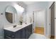 Modern bathroom with double sink vanity, marble floors, and contemporary lighting fixtures at 3359 Denise St, Durham, NC 27704