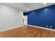 Spacious bedroom with hardwood floors, neutral walls, and a door leading to an additional space at 3359 Denise St, Durham, NC 27704