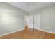 Bright bedroom with hardwood floors, ceiling fan, and a double-door closet at 3359 Denise St, Durham, NC 27704